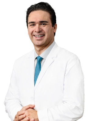 VTC_DrEtaee_Headshot_ (1)_optimized A professional headshot of Dr. Farshid Etaee wearing a white lab coat and a blue tie. He is smiling and posing against a plain white background.