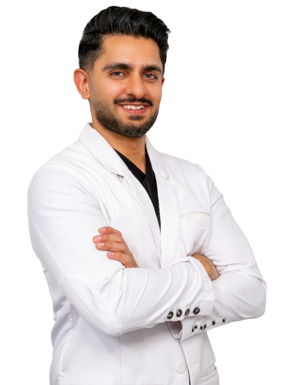 VTC_DrMehta_Coat_665x765_optimized Professional headshot of Dr. Akash Mehta wearing a white lab coat, smiling at the camera against a black background. This is a standard medical professional portrait used for clinic or practice identification.